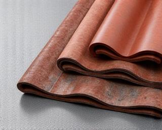 Rolls of insulation material and stacks of roofing tiles.